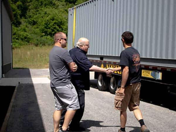 On-site handshake during A-Verdi storage container delivery to a customer.