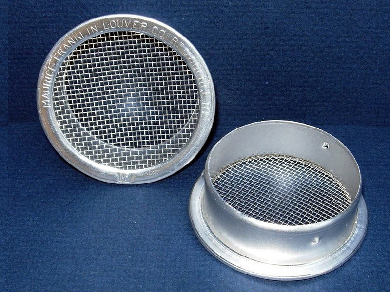 Two round aluminum vents with mesh screens, designed for airflow while preventing debris and pests.