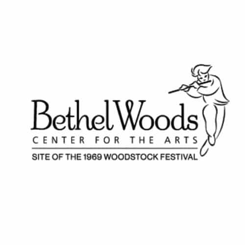 Black and white Bethel Woods logo featuring a figure playing a flute to the right of the text, with the words “Bethel Woods Center for the Arts” and “Site of the 1969 Woodstock Festival” below.