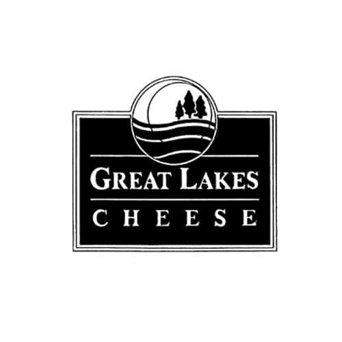 A bold, black rectangular logo with a circular emblem at the top featuring two trees and wavy lines representing a landscape. Below the emblem, the words "GREAT LAKES" appear in large uppercase serif font, with "CHEESE" in slightly smaller uppercase serif letters underneath, separated by horizontal lines.