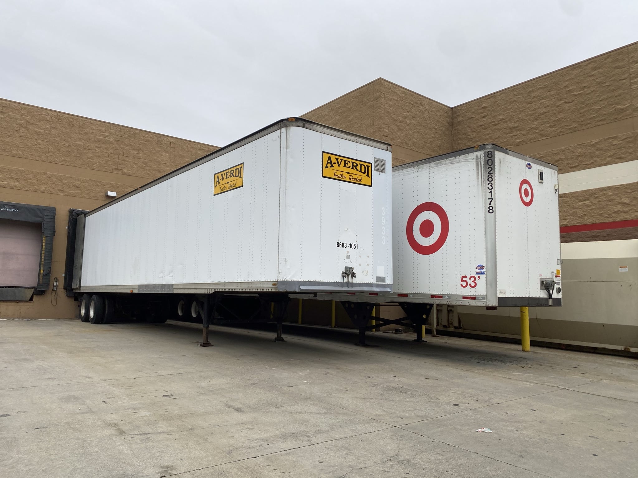 A-Verdi trailer rental parked at a retail store loading dock beside a Target trailer.