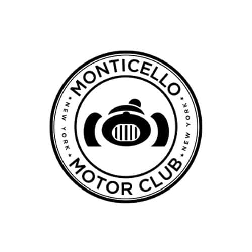 Black and white circular emblem with bold text “Monticello Motor Club” around the outer ring, separated by two small stars. In the center is a stylized race car grille flanked by abstract fender shapes and a helmet silhouette above.