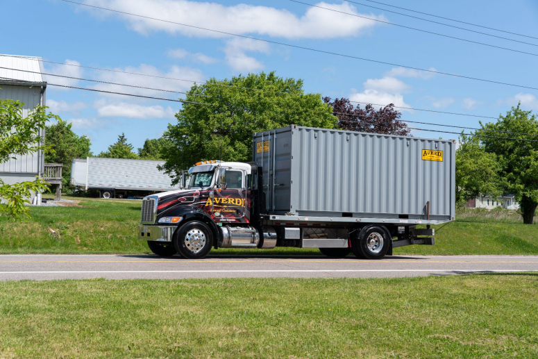 Image of a delivery truck delivering a storage container