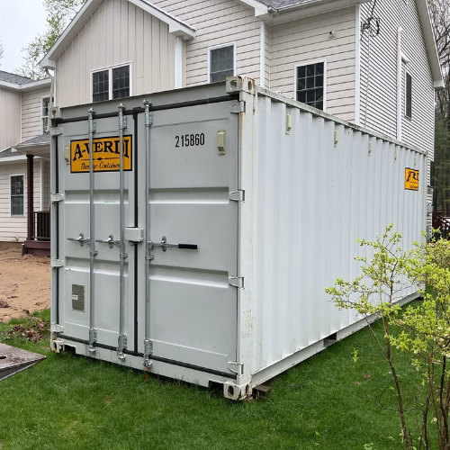 Protect What Matters During Your Home Renovation A residential storage container placed beside a home to protect furniture and belongings during a home renovation project.