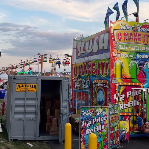 A-Verdi Deliver Secure Storage for Events Across New York A-Verdi storage container used for secure storage at a festival with food stands and carnival rides in the background.
